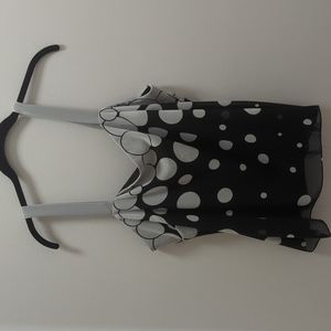 Two piece polka dot sleeveless blouse with matching cover.